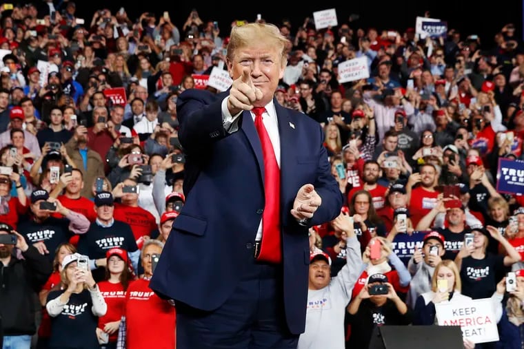 In this Jan. 9, 2020, photo, President Donald Trump points as he arrives to speak at a campaign rally, in Toledo, Ohio.
