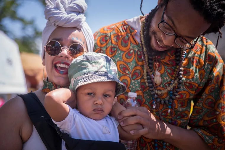 Azola Thomas-Owens, age 1, with his parents Heather (left) and Courtnee (right) at the Odunde festival on Grays Ferry Avenue, June 11, 2017.
