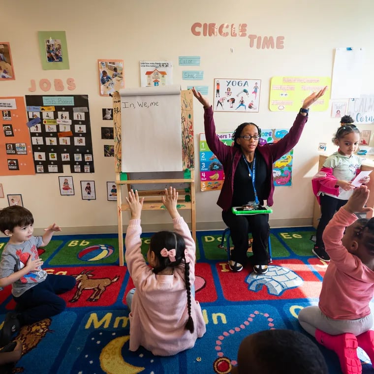 Teacher Denean Nelson leads her students in stretches before settling in for story time at the Kinder Academy in Philadelphia.