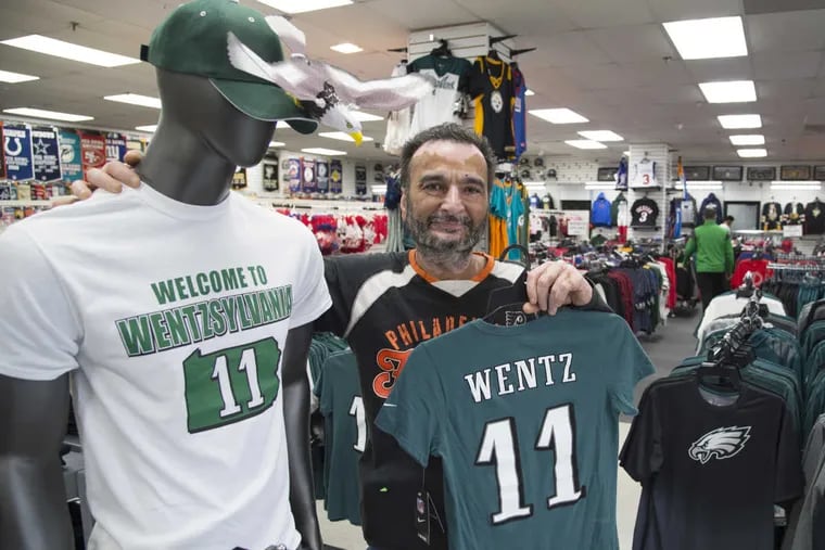 Randy Benipal, owner of Fan Treasures in Runnemede, N.J., stands next to a mannequin wearing a T-shirt saying “Welcome to Wentzsylvania” on Sept. 29, 2016.