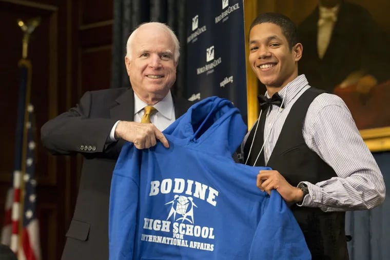 Anthony Williams presents Bodine High School sweatshirt to Senator John McCain at the World Affairs Council of Philadelphia, Dec. 1, 2014.