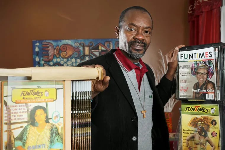 Eric Nzeribe with old and new copies of FunTimes Magazine, which he began publishing in Liberia in 1992, at the magazine’s office in West Philadelphia on Wednesday. On the left is an edition from the 1990s; top right is the November/December 2017 edition; and middle right is the first U.S. edition.
