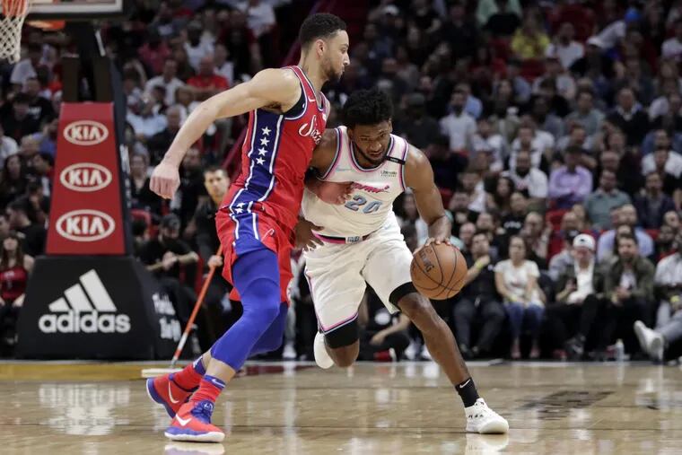 The Sixers’ Ben Simmons defends the Heat’s Justise Winslow (20) during the second half.