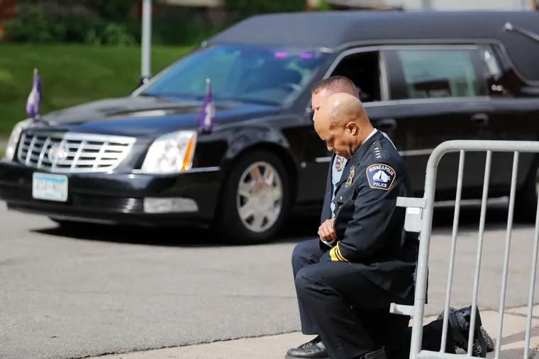 Police officers including Minneapolis Police Chief Medaria Arradondo, foreground, take a knee as the body of George Floyd arrives before his memorial service Thursday.