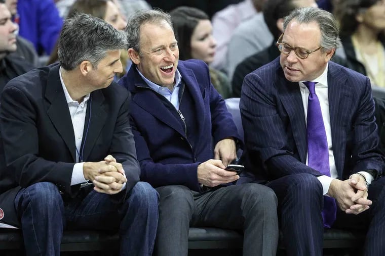 File photo shows Sixers' majority owner Josh Harris, center, watching his team play the Nuggets during the 1st quarter at the Wells Fargo Center in Philadelphia. STEVEN M. FALK / Staff Photographer