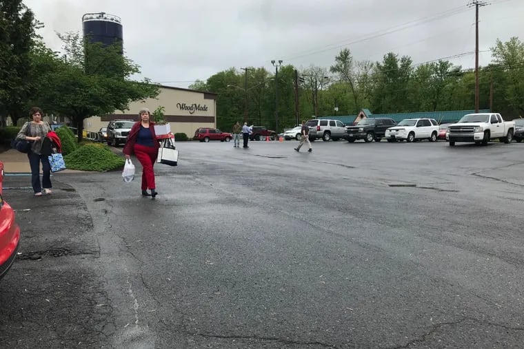 Employees walk out of Wood-Mode in Kreamer on Monday, May 13, 2019, after employees were informed the custom-cabinet maker is closing permanently.