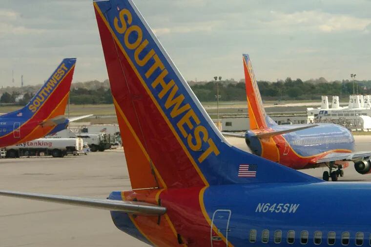 Southwest Airlane planes on the tarmac at Terminal E at the Philadelphia Interntional Airport.  ( Clem Murray  /Inquirer )