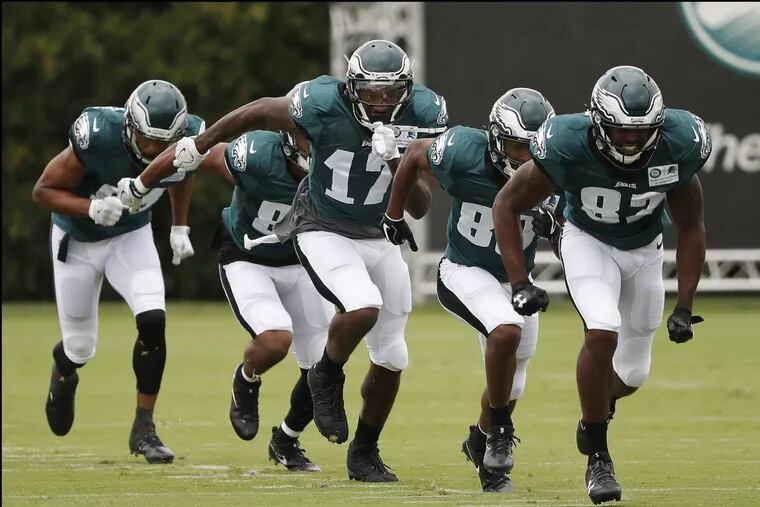 Eagles’ wide receivers, including Ashon Jeffery, center, run together at Eagles training camp on Saturday.
