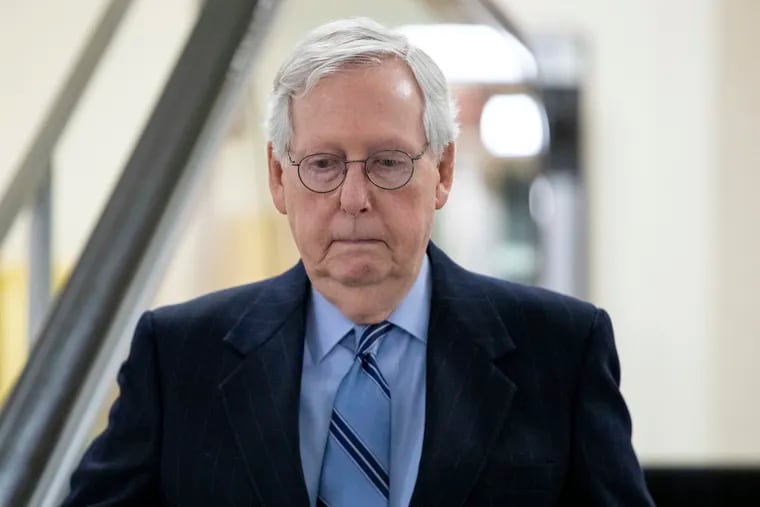 Senate Minority Leader Mitch McConnell, R-Ky. goes down an escalator at the Capitol in Washington.