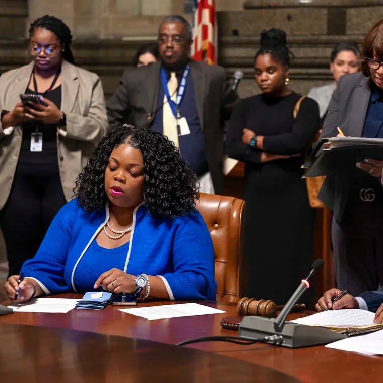 Philadelphia City Council president Kenyatta Johnson (right) and  majority leader  Katherine Gilmore Richardson go over bills and resolutions as they meet in caucus with other councilmembers Jan. 25. Gilmore Richardson intends to introduce legislation that would change how the city contracts with nonprofits.