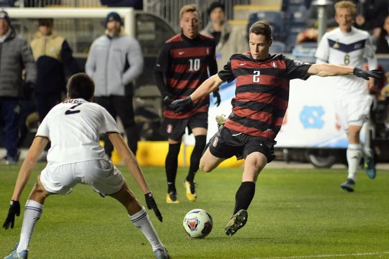 Stanford’s Foster Langsdorf (2) takes a shot as Akron’s Joao Moutinho (2) defends. Langsdorf scored the first goal of the 2-0 Stanford victory.