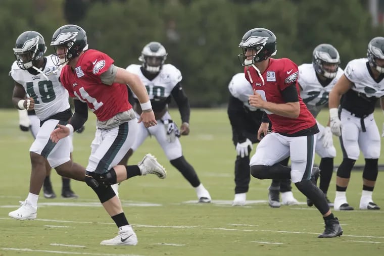 Philadelphia Eagles quarterback's, Carson Wentz, front, (11) and Nick Foles, (9) run during an early morning practice at the Eagles NovaCare Complex in Philadelphia, Pa. Sunday, August 12, 2018. JOSE F. MORENO / Staff Photographer