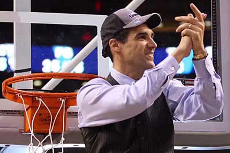 Head coach Jay Wright cuts down the net after Villanova defeated Pittsburgh to earn a spot in the Final Four for the first time since 1985. (Yong Kim / Staff Photographer)