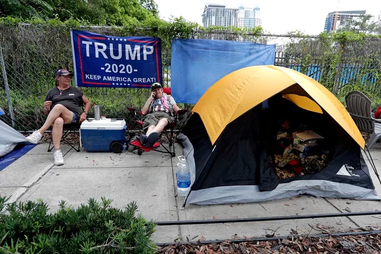 Anna Connelly, left, and Jeanna Gullett supporters of President Donald Trump, make camp Monday, June 17, 2019, in Orlando, Fla., as they wait to attend a rally for the president on Tuesday evening.