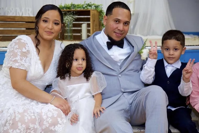 Michael Almonte at his wedding ceremony with his wife, Patricia, and two of his three children. Almonte was killed when a stray bullet struck his Uber vehicle last week.