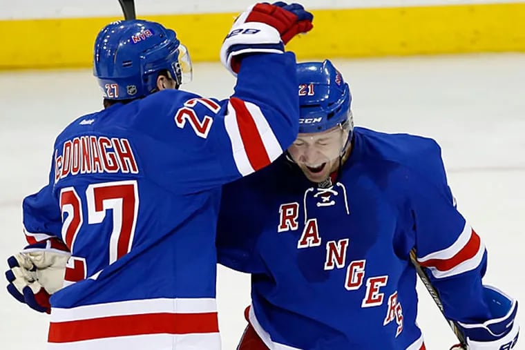 The Rangers' Derek Stepan (right) celebrates his goal with teammate Ryan McDonagh against the Flyers. (Yong Kim/Staff Photographer)