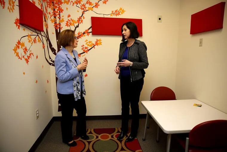 Beth Sturman, at left,  executive director of domestic violence agency Laurel House, talks with Abbie Newman, CEO of Mission Kids Child Advocacy Center of Montgomery County, in a child interview room in East Norriton, Pa., on April 19, 2018.