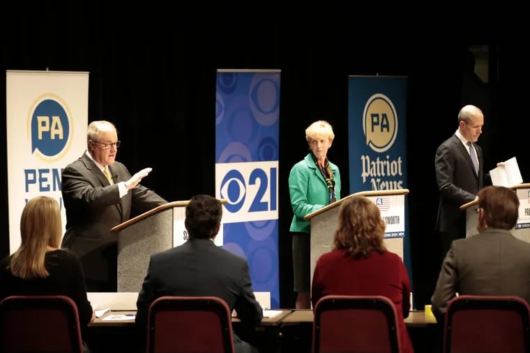 Pa. gubernatorial candidates State Sen. Scott Wagner (R., York), left, Laura Ellsworth, center, a lawyer from suburban Pittsburgh, and Paul Mango, right, a former health care systems consultant from suburban Pittsburgh, participate in a debate at Harrisburg Area Community College this month.
