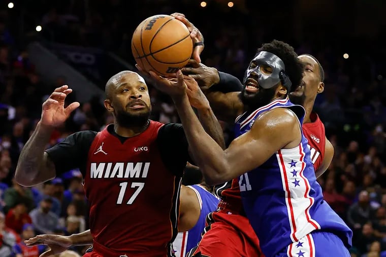 The Miami Heat's P.J. Tucker goes for a rebound with Sixers center Joel Embiid during their playoff series in May.