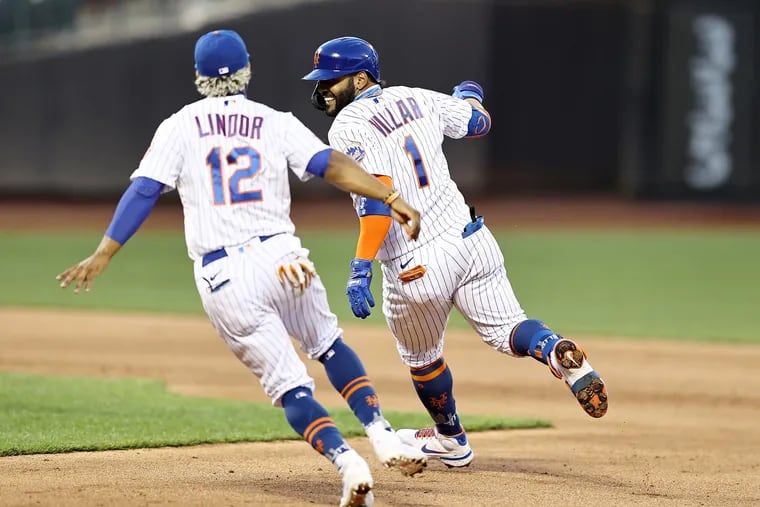 Jonathan Villar (1) of the New York Mets celebrates his hit, which drove in the game-winning run, as he is chased by teammate Francisco Lindor (12) in the eighth inning against the  Phillies.