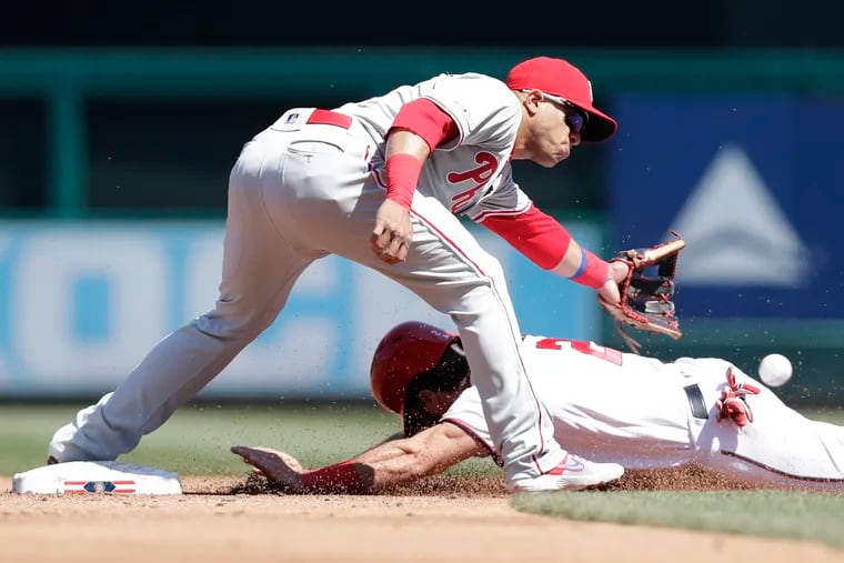 Cesar Hernandez misses the throw as the Nationals' Adam Eaton slides into second base on a third-inning steal.