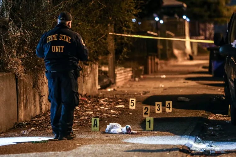 Crime scene investigators examine the scene of a homicide at Hawthorne and Harrison Streets on March 15. Amid an ongoing gun violence crisis, about 70% of Philadelphians say public safety is the number 1 issue affecting the city.