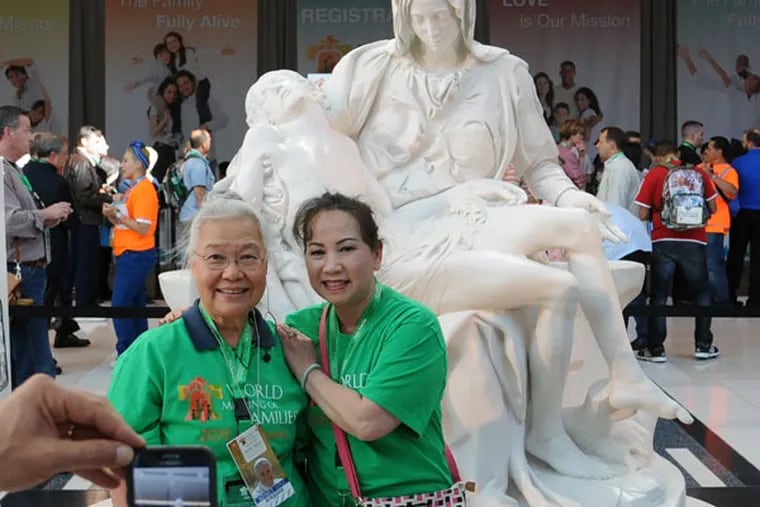 Visitors Anh Kim (left) and Huong Thy are among those in town this weekend. (CLEM MURRAY/Staff Photographer)