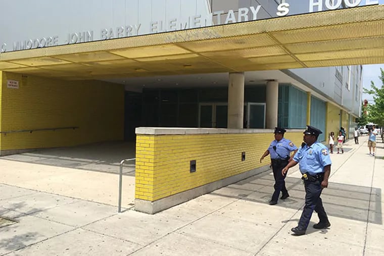 Police respond to a report of a child with unknown substance at Commodore John Barry Elementary School at 59th and Race Streets in Philadelphia. (Alejandro Alvarez/Staff Photographer)