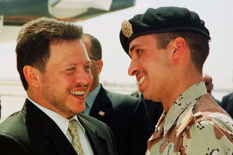 In this 2001 file photo, Jordan’s King Abdullah II laughs with his half brother Prince Hamzah, right, shortly before the monarch embarked on a tour of the United States. A new audio recording that circulated online Tuesday, seems to capture an explosive meeting between Prince Hamzah and the army chief of staff that triggered a rare public rift at the highest levels of the royal family.