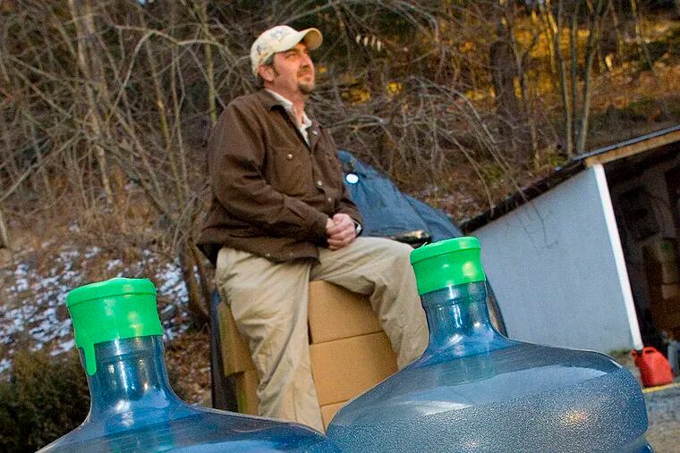 File: Scott Ely sits on cases of bottled water delivered weekly to his home on Carter Road in Dimock, Pa. in this photo taken Dec. 21, 2010.