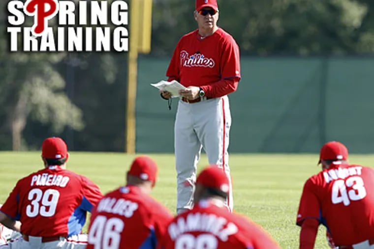 Rich Dubee goes over his plan with Phillies pitchers at Bright House Field in Clearwater.  (Yong Kim / Staff Photographer)