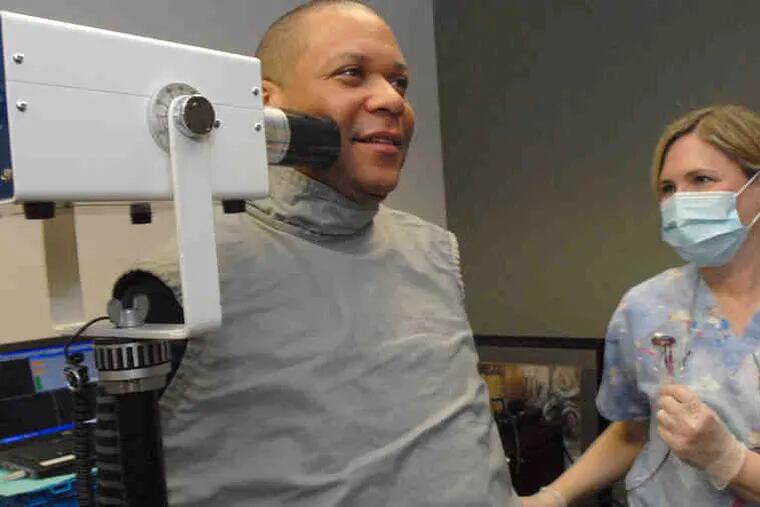 Bandleader and drummer Leon Jordan is X-rayed by hygienist Cheryl Luzetski. His wife Phaedra, left, gets her turn. The Grammys' MusiCares hired the serivce for area musicians.
