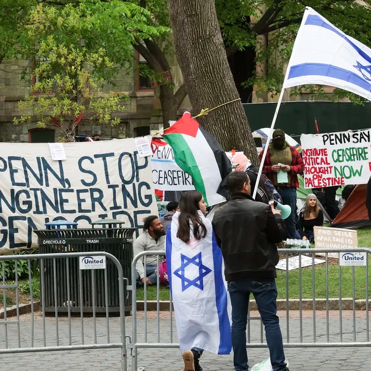 Counter-protestors in support of Israel stand across from the encampment in support of Palestine at College Green on the campus of Penn in Philadelphia on Saturday. The Penn protesters are calling for the university to disclose its financial holdings, divest from any investments in the war, and provide amnesty for pro-Palestinian students facing discipline over past protests.