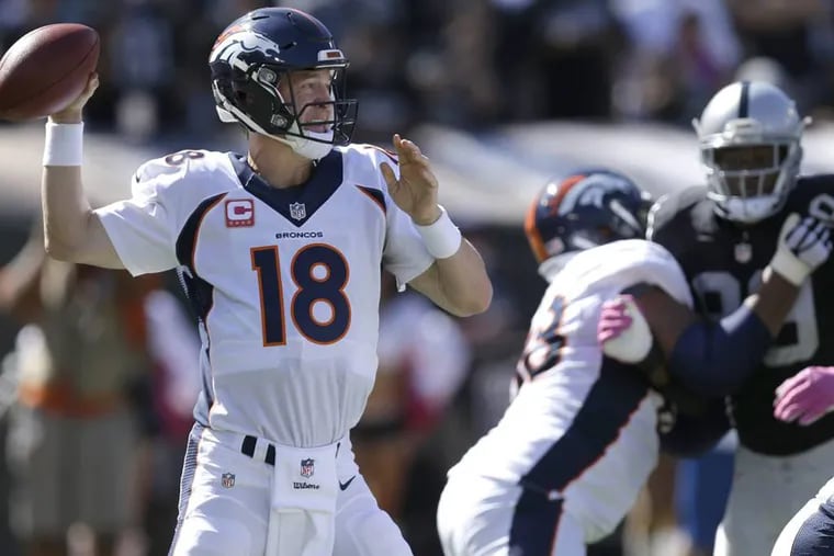 Denver Broncos quarterback Peyton Manning (18) passes against the Oakland Raiders during the first half of an NFL football game in Oakland, Calif., Sunday, Oct. 11, 2015.