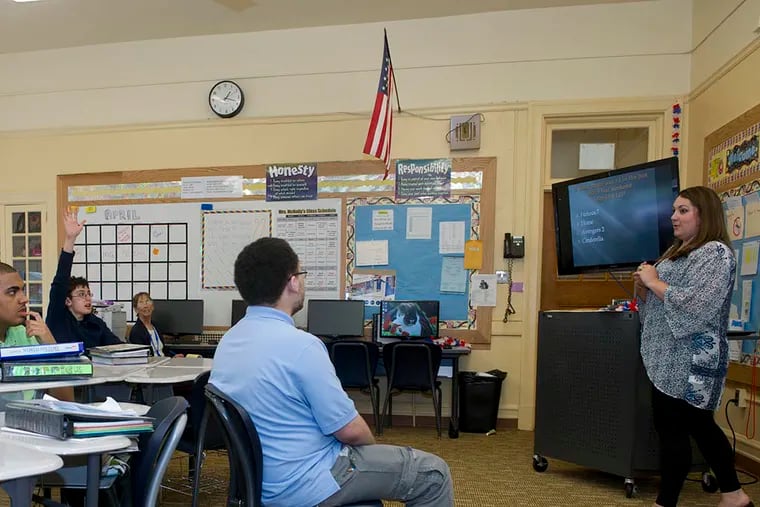 Y.A.L.E. School teacher Nicole McNally leads her world history class in a competitive current-events project quiz at the school's Cherry Hill campus. Students note how they have had to build teamwork skills through the project. (AVI STEINHARDT / For The Inquirer)