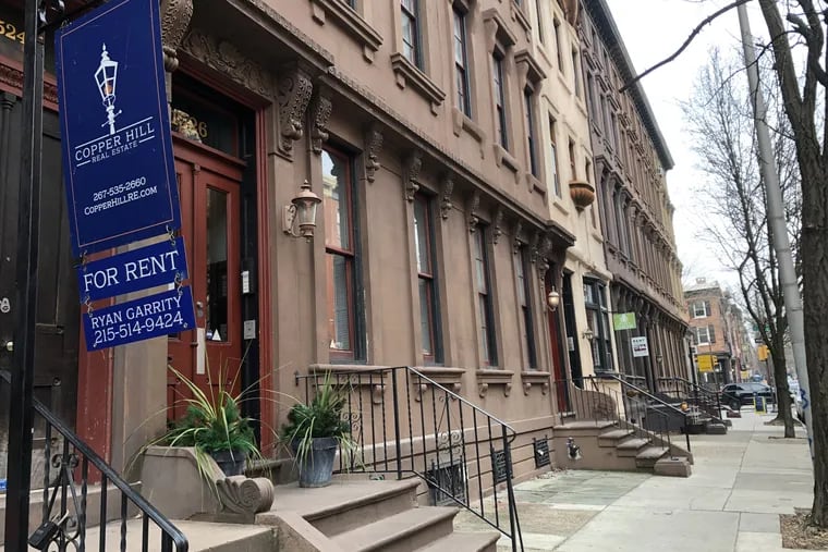 Signs advertising rental units lined a block on Pine Street in Center City this winter.