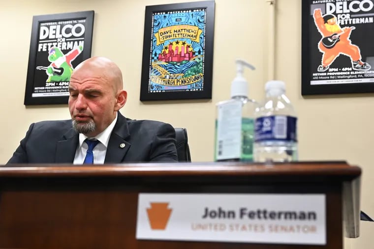 Sen. John Fetterman works in his windowless, temporary, freshman basement Capitol office Tuesday, Apr. 18, 2023.