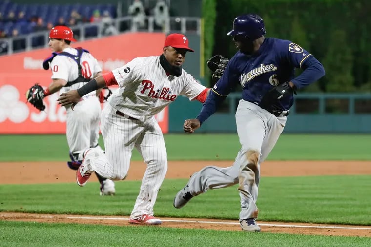 Phillies shortstop Jean Segura tagging out the Brewers' Lorenzo Cain during a fourth-inning rundown Monday. The Phillies improved to 24-16 with the victory.