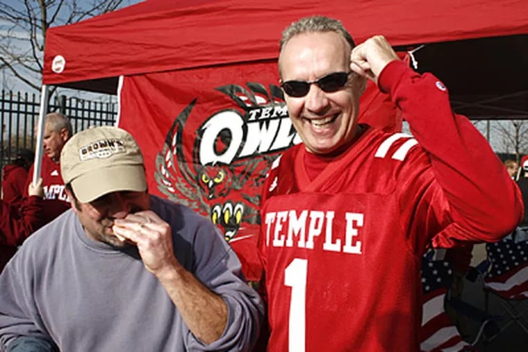 Rich Gabe, right, a serious Temple fan, and his friend Joe Lisa tailgate with friends before the Owls' 47-13 win over Kent State on Saturday. (Ed Hille / Staff Photographer)