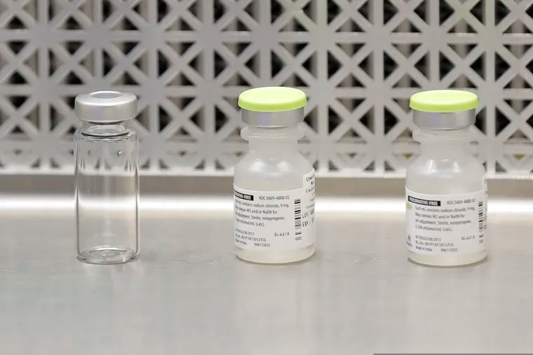 This March 16 photo shows vials used by pharmacists to prepare syringes used on the first day of a first-stage safety study clinical trial of the potential vaccine for COVID-19 in Seattle.