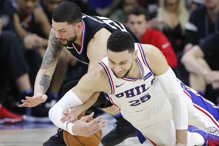 Sixers guard Ben Simmons and Los Angeles Clippers guard Austin Rivers go after the loose basketball during the fourth-quarter on Saturday, February 10, 2018 in Philadelphia.