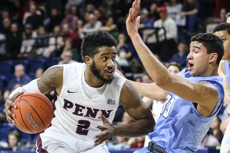Penn's Antonio Woods fouls Columbia's Tai Bibbs during the first half at The Palestra in Philadelphia, Friday February 22, 2019