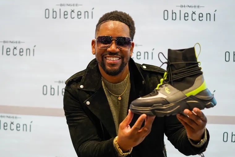 Darrell Alston holds up a Bungee high-top shoe at Foot Locker in King of Prussia Mall in King of Prussia, Pa., on November 6, 2021. Darrell Alston launched his footwear brand Bungee at Foot Locker on Saturday.
