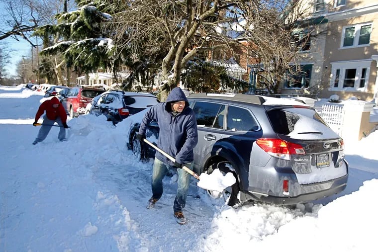 Papo Lopez digging out his boss’ car on Carpenter Lane in Mount Airy on Sunday morning. The region had to handle nearly two feet of snow—or more.
