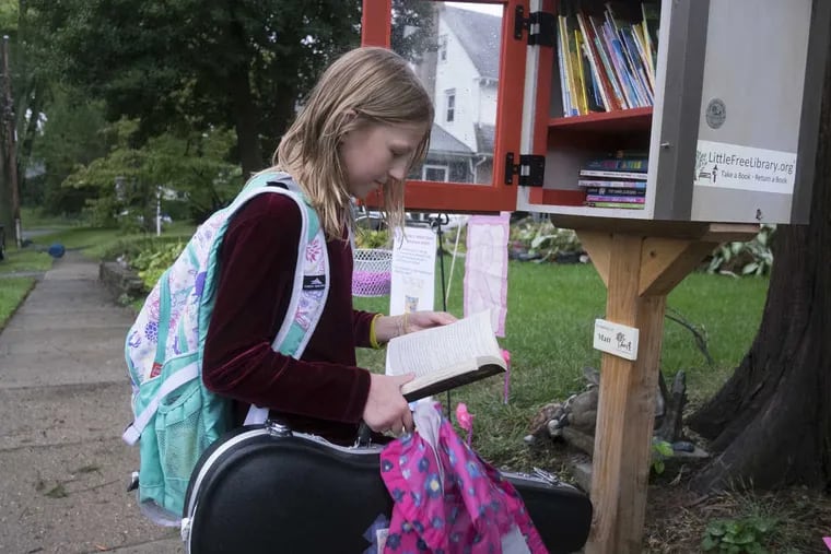 10-year-old Genevieve Chermside stops on her way from school and picks out a book from the little library at Margit Novack&#039;s home in Ardmore.