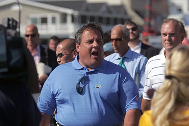 Gov. Christie walks the boardwalk of Belmar, N.J., Wednesday. (The Asbury Park Press, Tom Spader / Associated Press)