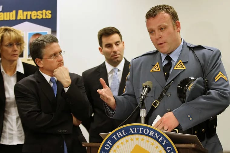 Detective Rich Wheeler of the State Police financial-crimes division, with acting Attorney General John J. Hoffman (left), describes the alleged elder-care fraud in Atlantic County. Nine of the 10 victims have died.