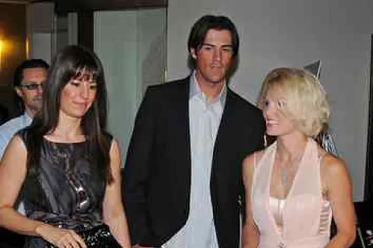 Phillies pitcher Cole Hamels and wife Heidi Strobel (right) are welcomed to the Residences at Two Liberty Place, where they bought a condo. At left is Sarah Schaffer, editor of Philadelphia Style, which threw the party Monday.