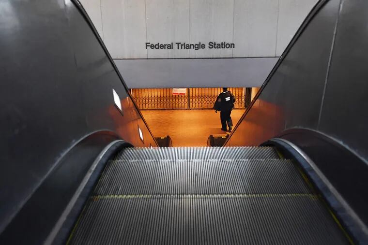 A transit officer patrols a closed Washington Metro station.