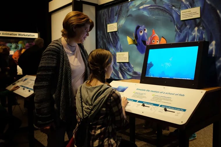 Susan Knorr and daughter Megan of Warminster interact with a &quot;Finding Nemo&quot; installation at the Franklin Institute's show &quot;The Science Behind Pixar.&quot;